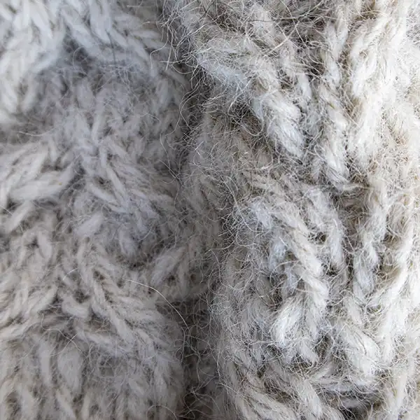 Close-up detail of white cable-knit alpaca beanie