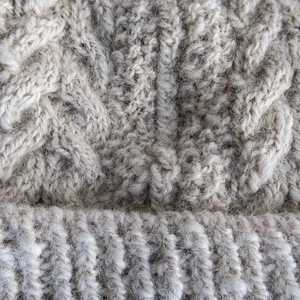 White cable-knit alpaca beanie detailed view