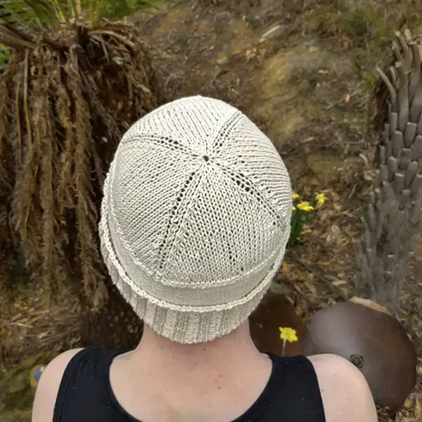 A man is wearing a cotton beanie -m showing the crown pattern of the beanie